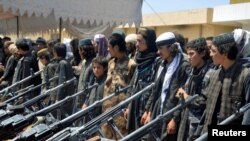 Members of Islamic State hand over their weapons to the Afghan forces during a ceremony in Jawzjan Afghanistan on August 2.