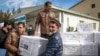 Afghan healthcare workers unload the first shipment of COVID-19 vaccines donated by the Indian government at the Kabul airport on February 7.