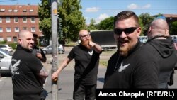 Some of the demonstrators wore black shirts branded with "Defensive West MG."