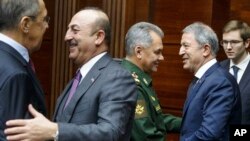 Russian Foreign Minister Sergey Lavrov, left, and Turkey's Foreign Minister Mevlut Cavusoglu,meet in Moscow (AP)