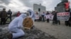 Communist Party supporters dressed as white bears saw through a replica of a Russian ruble coin during a protest rally against the policies of the Russian government in front of parliament in Moscow on December 22.