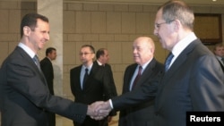 Syria -- President Bashar al-Assad (L), welcomes Russian Foreign Minister Sergei Lavrov to Damascus, 07Feb2012