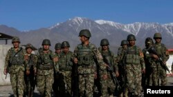 FILE: Afghan National Army (ANA) soldiers prepare to leave their base for a patrol near Kabul. 