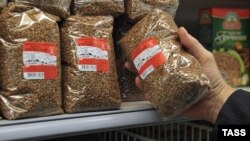 Russia - A shopper holds a buckwheat packet at a Moscow supermarker, March 20, 2020.