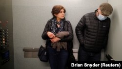 Maziar Hashemi (right), who has the cancer Myelodysplastic syndrome, and his wife, Fereshteh, leave in an elevator after meeting with his transplant doctor at a hospital in Boston, Massachusetts, on March 26.