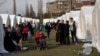 ALBANIA -- People stand outside their tents at a makeshift camp after an earthquake in Thumane, western Albania, November 27, 2019