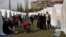ALBANIA -- People stand outside their tents at a makeshift camp after an earthquake in Thumane, western Albania, November 27, 2019