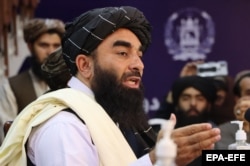 Taliban spokesman Zabihullah Mujahid talks with journalists during a press conference in Kabul on August 17.