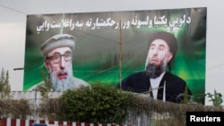 FILE: A banner with pictures of Gulbuddin Hekmatyar in Kabul.