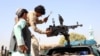 Afghan policeman position a heavy machine gun on a pickup truck to target Taliban positions near the southern Afghan city of Kandahar. 