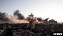 SYRIA - Smoke rises in Damascus after Syrian rebels announced that they have ousted Syria's Bashar al-Assad, December 8, 2024.