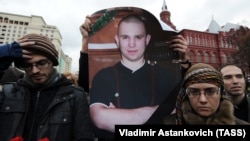 Members of anti-fascist movements hold a poster depicting Antifa group leader Ivan Khutorskoy during a meeting in his memory near the Kremlin in Moscow. (file photo)