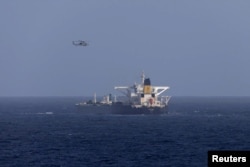 Военный вертолет США над танкером под панамским флагом, перехваченным Береговой охраной США, к востоку от Барбадоса в Карибском море. 20 декабря 2025 года.