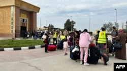 Passengers fleeing from the Gaza Strip arrive in the Egyptian part of the Rafah border crossing on November 12. 