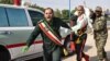 An Iranian soldier carrying an injured comrade at the scene of an attack on a military parade in Ahvaz on September 22.