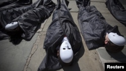 Campaigners from the Control Arms Coalition lay in fake body bags to demonstrate in front of the UN building in New York on July 2.