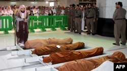 A Saudi cleric and mourners pray in the holy mosque in Mecca on January 6 during the funeral of three Saudi guards who were killed in an attack and suicide bombing and another two other bodies who died in other circumstances.