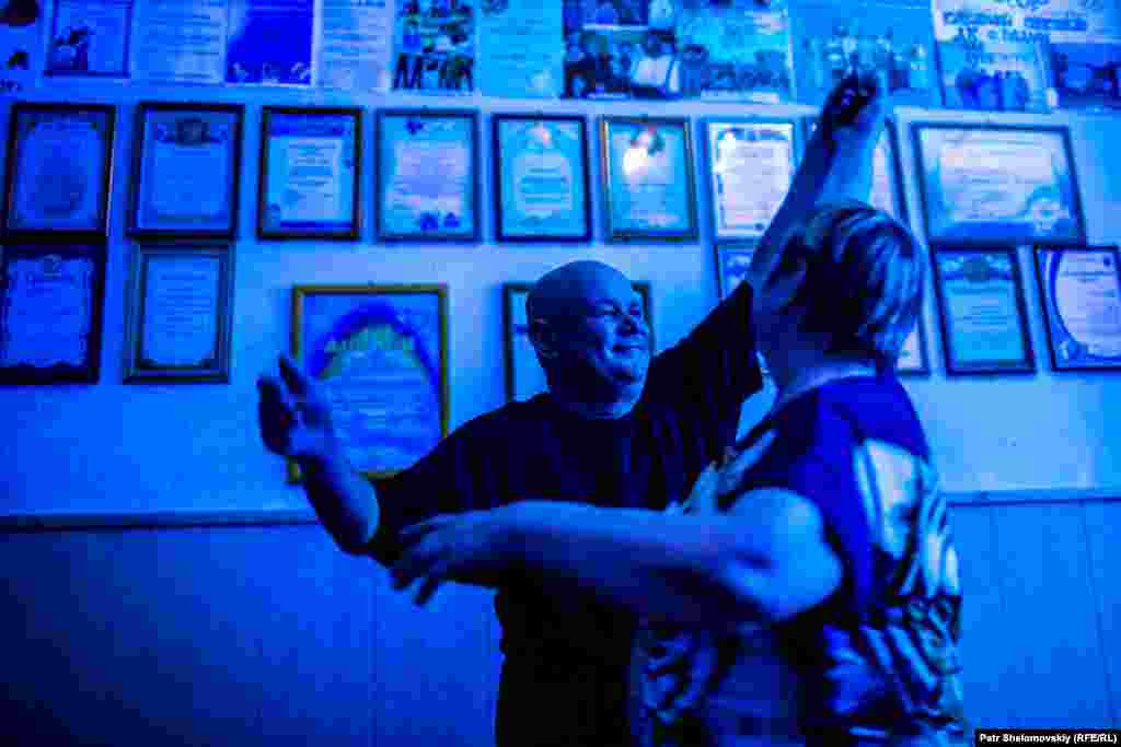 Locals dance at a social club. Days later, the building was transferred to the monastery, which repurposed it as a cafeteria.