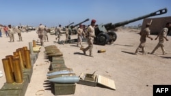 Iraqi security forces prepare to fire artillery during fighting against jihadists from the Islamic State (IS) group in the Garma district, west of the Iraqi capital, Baghdad, in the Anbar Province's eastern edge on April 26.