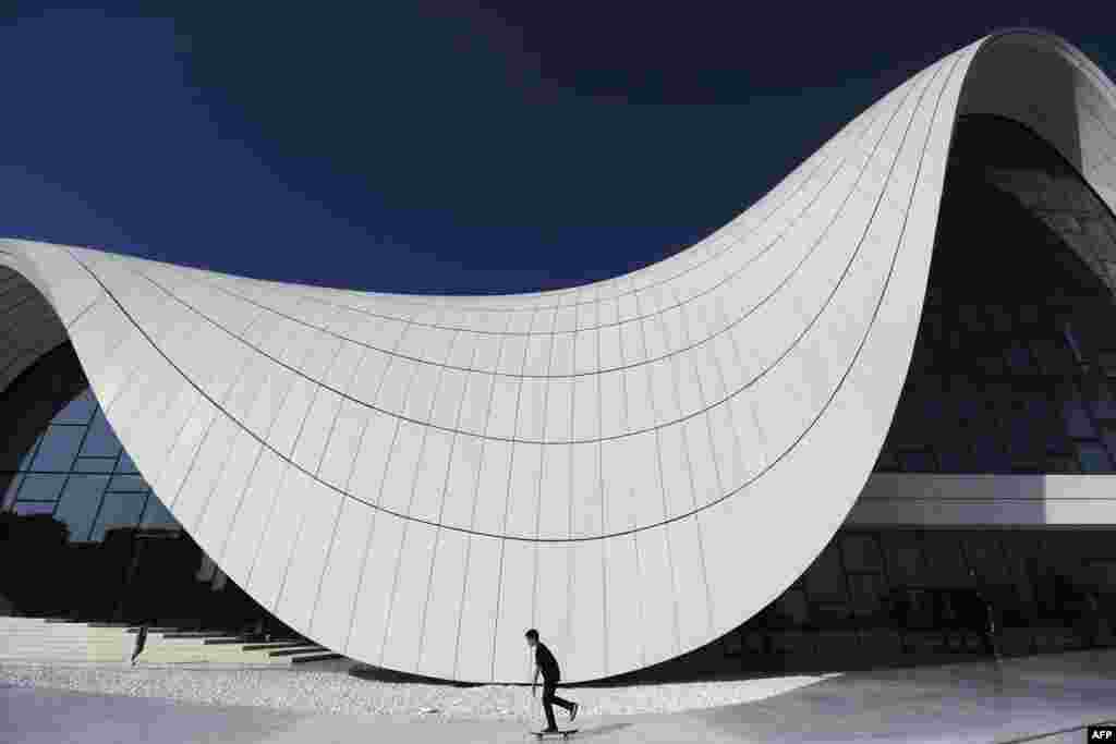 A child skateboards in front of the Heydar Aliyev Center in Baku. (AFP/Benjamin Cremel)