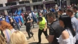 Serbia - Participants in the protests on International Labor Day in Belgrade who shout to Serbian Minister of Labor Zoran Djordjevic "Zoran, you thieve" are trying to reach him while he is leading the protest column. Belgrade, 1. May 2018.