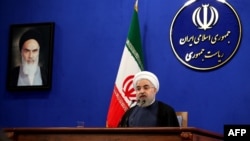 Iranian President Hassan Rohani delivers a speech next to a portrait of the founder of Iran's Islamic republic, Ayatollah Ruhollah Khomeini, during a press conference in Tehran last month.