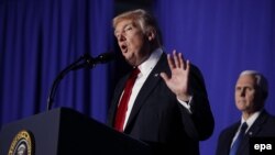 U.S. President Donald Trump delivers remarks during a visit to the Department of Homeland Security with Vice President Mike Pence (R) in Washington on January 25.