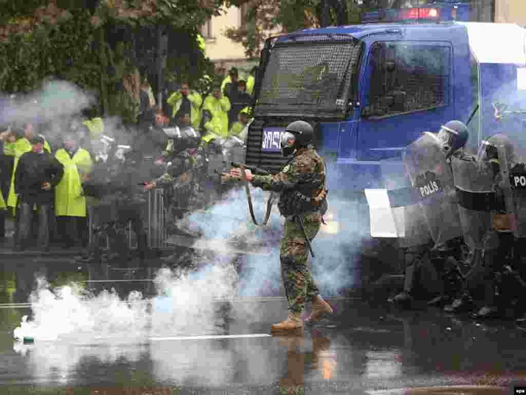 Georgian police fire tear gas to disperse opposition protesters at a rally in central Tbilisi on November 7, 2007. At about 5 a.m. CET on Wednesday the police assumed control over the square in front of the Georgian parliament building using force to disperse opposition members. (EPA photo)