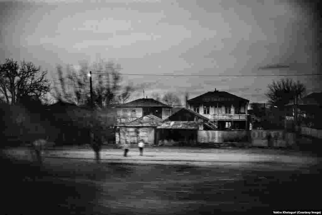 Passing suburbs on a winter evening