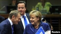 Polish Prime Minister Donald Tusk, British Prime Minister David Cameron, and German Chancellor Angela Merkel (left to right) talk at an EU summit in Brussels in late October.