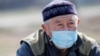 Kazakhstan - A man wearing a protective mask is seen near a check point, following the Kazakh state emergency commission's decision to lock down Almaty to prevent the spread of coronavirus disease (COVID-19), on the outskirts of Almaty, Kazakhstan March 1