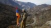 ARMENIA -- An ethnic Armenian soldier stands guard flag atop a hill in northwestern Karabakh, November 25, 2020