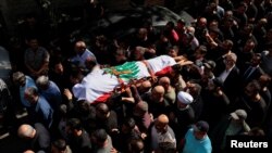Fotografie de la înmormântarea jurnalistului Issam Abdallah, de la agenția de presă Reuters, ucis de o bombă israeliană la granița dintre Liban și Israel.