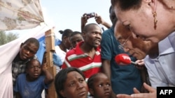 UN Secretary-General Ban Ki-moon speaks with displaced Haitians in front of the Haitian National Palace in Port-au-Prince on January 17.