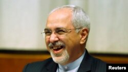 Switzerland -- Iranian Foreign Minister Mohammad Javad Zarif smiles at a plenary meeting at the start of three days of closed-door nuclear talks at the United Nations European headquarters in Geneva November 20, 2013.