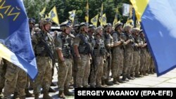 Soldiers of the Azov Battalion during a parade in 2015: one of the two men was found guilty of providing Russian troops with coordinates locating the unit.