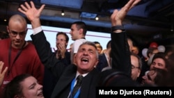 Ilija Srdanovic, a leading candidate on the Students List, celebrates following the first results of the Serbian parliamentary vote.