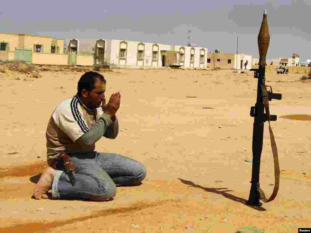 A rebel fighter prays along a road in Wadi Al-Hamra on March 28. Photo by Youssef Boudlal for Reuters