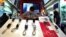 A shopkeeper adjusts mobile-phone handsets at a shopping center in Tehran. (file photo)