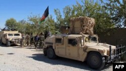 Afghan security personnel patrol in Lashkar Gah, capital of Helmand Province on October 21.