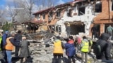 Residents of the Ukrainian town of Kropyvnytskiy clear rubble following a Russian drone attack on March 20. 