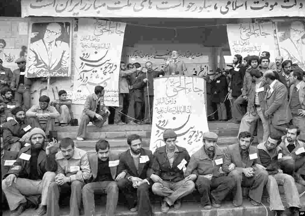 Heavily guarded by security, Mehdi Bazargan makes a speech at Tehran University on February 9, 1979. Bazargan was Ayatollah Ruhollah Khomeini&#39;s choice to take over Iran&#39;s government. Bazargan declared he would introduce Allah to all phases of Iranian life, revamp the economy, and hold free elections before resigning to make way for an Islamic regime.