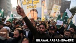 People shout slogans during a protest against the sentencing to death of former President Pervez Musharraf in Peshawar on December 24.