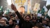 People shout slogans during a protest against the sentencing to death of former President Pervez Musharraf in Peshawar on December 24.