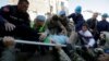 Military and emergency personnel put an injured man on a stretcher near a damaged building in Thumane, after an earthquake shook Albania, November 26, 2019. REUTERS/Florion Goga