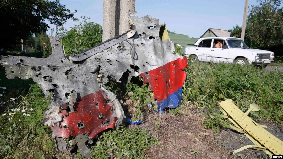 A piece of the wreckage is seen at a crash site of the Malaysia Airlines Flight 17 in the village of Petropavlivka (Petropavlovka), in the Donetsk region of eastern Ukraine, on July 24, a week after the crash. 