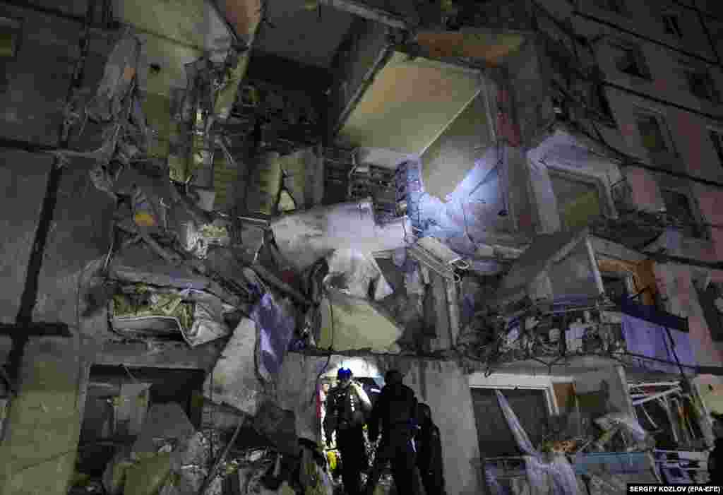 Ukrainian rescuers working at the site of a Russian glide-bomb attack late at night on a nine-floor residential building in Kharkiv on October 30. The attack left three people dead and at least 36 wounded. Two boys, aged 11 and 15, were among the dead, authorities reported.