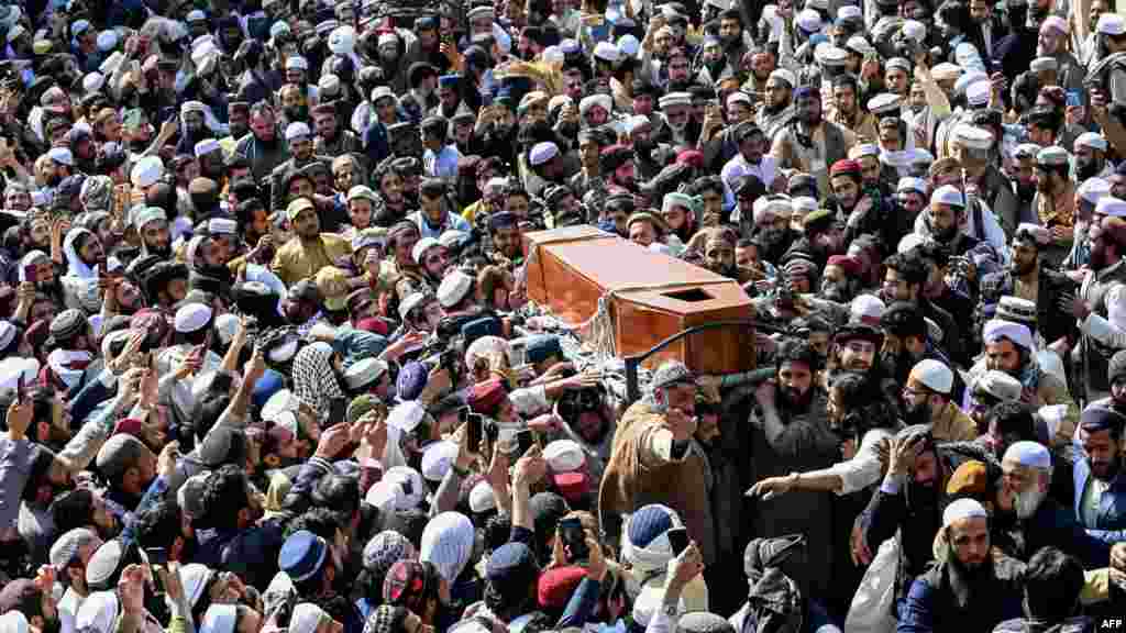 Mourners carry the coffin of Hamid ul Haq Haqqani, a Pakistani politician and cleric who was killed in a deadly suicide bombing in Khyber Pakhtunkhwa Province on February 28. 