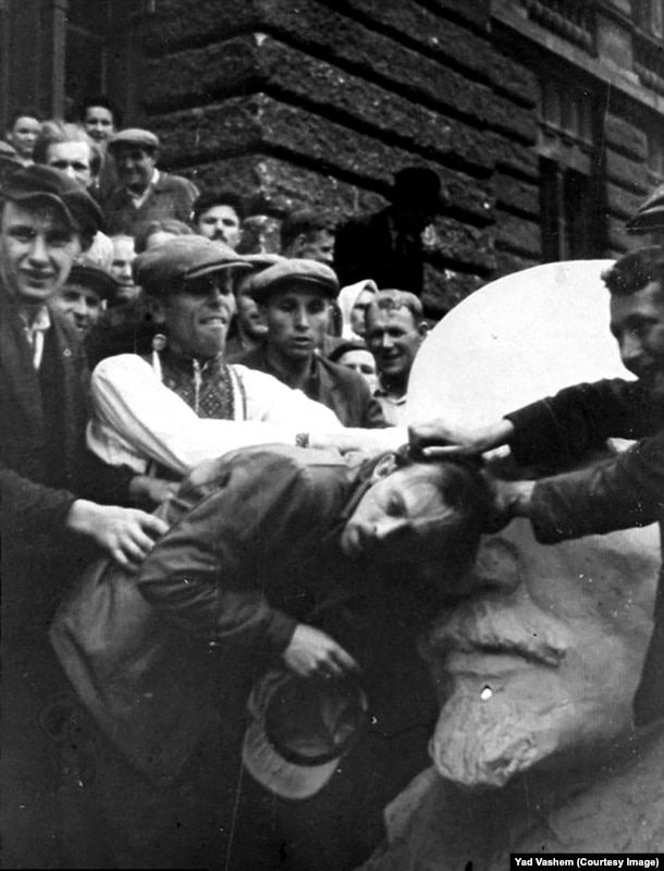 A Jewish man in western Ukraine being attacked by a mob next to a bust of Lenin. After occupying Nazi forces opened Soviet secret police prisons, atrocities carried out under Stalin were laid bare and exploited by Nazi propagandists, who fueled anti-Semitism by highlighting the Jewish backgrounds of some early Soviet leaders.