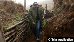 Armenian Prime Minister Nikol Pashinian walks through trenches in Nagorno-Karabakh on the "line of contact" with Azerbaijan during a visit in September.